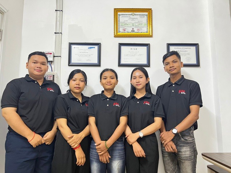 FBL Beef team members in front of the company's certificates